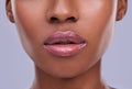 Lucious lips. Cropped shot of a young womans mouth against a purple background. Royalty Free Stock Photo