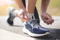 Cropped shot of young women runner tightening running shoe laces Royalty Free Stock Photo