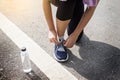 Cropped shot of young women runner tightening running shoe laces Royalty Free Stock Photo