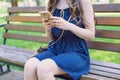 Cropped side profile close up photo of one charming user lady holding telephone in golden case leaving feedbacks on social media Royalty Free Stock Photo