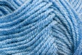 Cropped skein of pale blue woolen knitting thread texture. Ball of soft woolen yarn full frame macro photography. Knitting threads Royalty Free Stock Photo