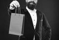 Cropped Smiling Man In Tuxedo Bow Tie Presenting Shopping Bag. Birthday. Copy Space.