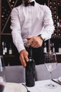 Cropped of sommelier opening bottle of