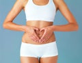 For the greatest wealth, invest in your health. Cropped studio shot of a fit young woman making a heart shaped gesture Royalty Free Stock Photo