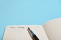 Cropped studio shot of an open notebook, organizer, diary with word Dear Diary and an ink pen isolated on blue background with Royalty Free Stock Photo