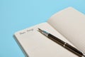 Cropped studio shot of an open notepad with word Dear Diary and an ink pen isolated on blue background with copy space Royalty Free Stock Photo