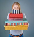 Happy birthday to you. Cropped studio shot of a young woman holding a stack of presents. Royalty Free Stock Photo