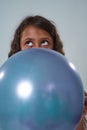 Cropped of thoughtful kid hold balloon and look up