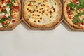 Cropped of three pizzas in open cardboard boxes