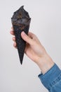 Cropped vertical close up view photo of hand in jeans denim shirt holding advertising showing tasty delicious icecream with brown Royalty Free Stock Photo