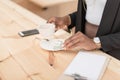 African american woman with coffee cup paying with cash in cafe Royalty Free Stock Photo
