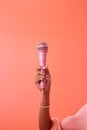 cropped view of African American woman holding microphone isolated on orange Royalty Free Stock Photo