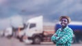 Cropped view of African man standing next to his truck, professional truck driver with arms crossed standing by tanker truck Royalty Free Stock Photo