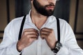 cropped view of bearded man in white shirt and suspenders