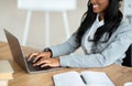 Cropped view of black business lady typing on laptop keyboard at office, closeup Royalty Free Stock Photo