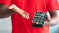 Cropped view of black man in uniform holding POS machine Royalty Free Stock Photo