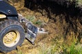 Cropped view of bulldozer bucket digging trench