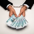 View of businessman in handcuffs holding russian money on white Royalty Free Stock Photo