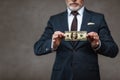 View of businessman holding dollar banknote on grey Royalty Free Stock Photo