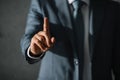 cropped view of businessman in suit pointing up