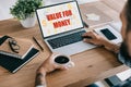 cropped view of businessman using laptop with value for money lettering and holding cup of coffee