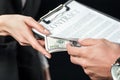 cropped view of businesspeople holding contract and bribe, Royalty Free Stock Photo