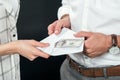 cropped view of businesspeople holding envelope with money, Royalty Free Stock Photo