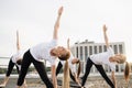 Sportswomen stretching together in yoga poses in open air Royalty Free Stock Photo