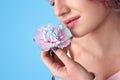 Young adult woman smell fresh carnation flower
