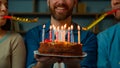 Cropped view caucasian adult happy bearded man celebrate birthday at home diverse african caucasian friends congratulate Royalty Free Stock Photo