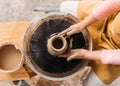 cropped view of child making ceramic pot with clay on pottery wheel Royalty Free Stock Photo