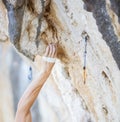 Climber`s hand gripping handhold on cliff