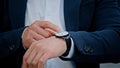 Cropped view closeup male hand with wristwatch clock Asian middle-aged businessman manager man male boss company CEO