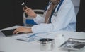 Cropped view of doctor in white coat holding bottle medication, prescribing pills to sick patient via online consultation. Family