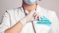 Cropped view of doctor in a white coat and sterile gloves holding a note with words - Bacterial Meningitis