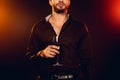 Cropped view of elegant man holding glass of red wine Royalty Free Stock Photo