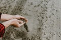 Cropped view of farmer hands pouring dry sandy soil Royalty Free Stock Photo