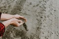 Cropped view of farmer hands pouring dry sandy soil