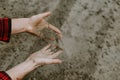 Cropped view of farmer hands pouring dry sandy soil