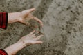 Cropped view of farmer hands pouring dry sandy soil Royalty Free Stock Photo