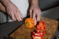 Cropped view father teaching kid to cut vegetables in the kitchen