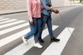 Cropped view of female caregiver assisting visually impaired black man with cane cross city street, closeup Royalty Free Stock Photo