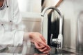 Cropped view of female chef washing hands over Royalty Free Stock Photo