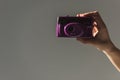 cropped view of female hand holding purple photo camera, Royalty Free Stock Photo