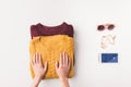 cropped view of female hands with sweaters, sunglasses and smartphone with facebook appliance,