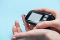 Cropped view of female hands testing glucose level with glucometer Royalty Free Stock Photo