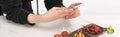 Cropped view of female photographer making food composition for commercial photography on smartphone Royalty Free Stock Photo