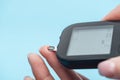 Cropped view of fingers and glucometer isolated Royalty Free Stock Photo