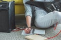 cropped view of girl with electric guitar writing song in copybook while sitting Royalty Free Stock Photo