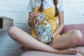 cropped view of girl putting dollar banknote into saving